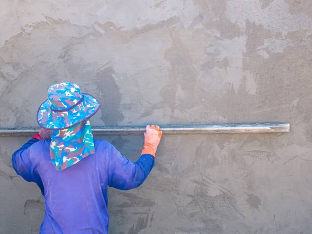 asian-plasterer-using-long-trowel-to-plastering-ce-2024-01-10-18-55-21-utc
