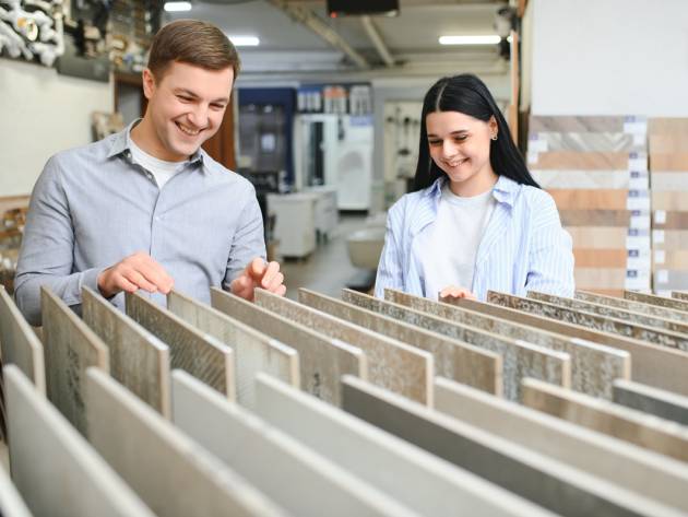 Beautiful young couple choosing ceramic tiles.